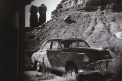 Old car in Utah with rock formation